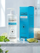 HISTEMO shampoo bottle and packaging on a marble surface with limes and mint leaves.